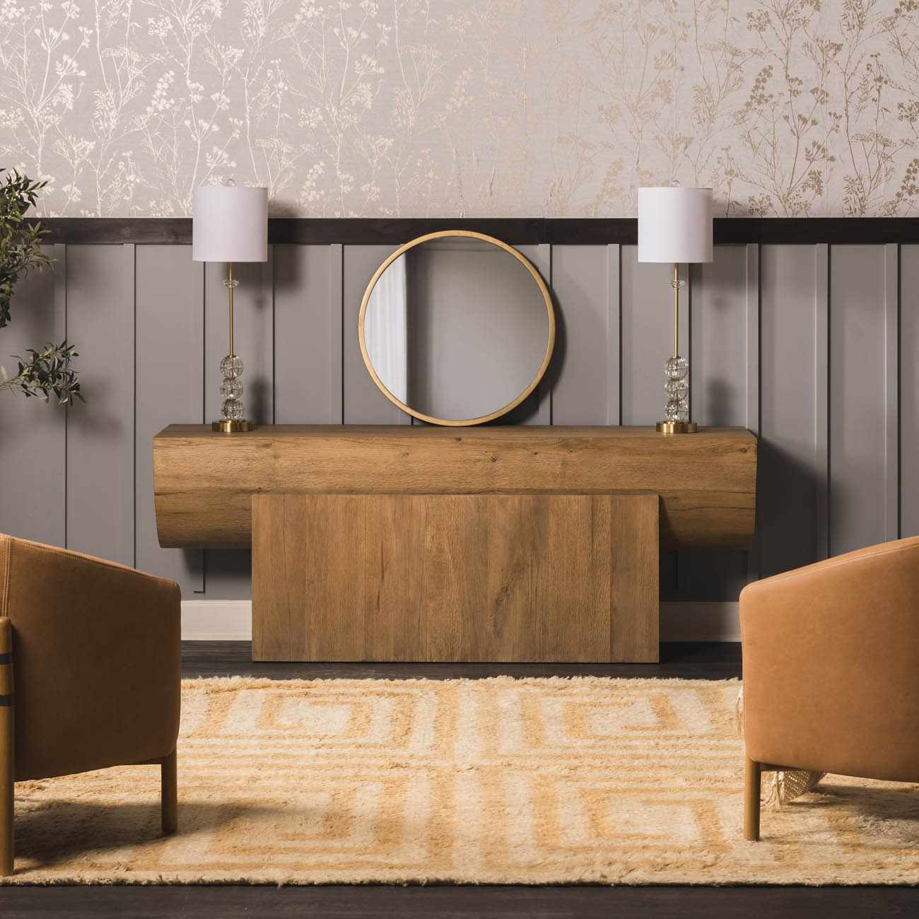 Entryway scene with a tan Wasim Area Rug, wood console table, round mirror, and camel-colored chairs. Roomscene-Rectangle