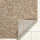 Close-up of the Thanh Beige Area Rug showing woven texture and colors: beige, coral, mustard, and terracotta. Fold