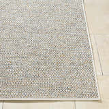 Close-up of the woven texture and neutral colors of the Thanh Ivory Area Rug on a beige tile floor. Front