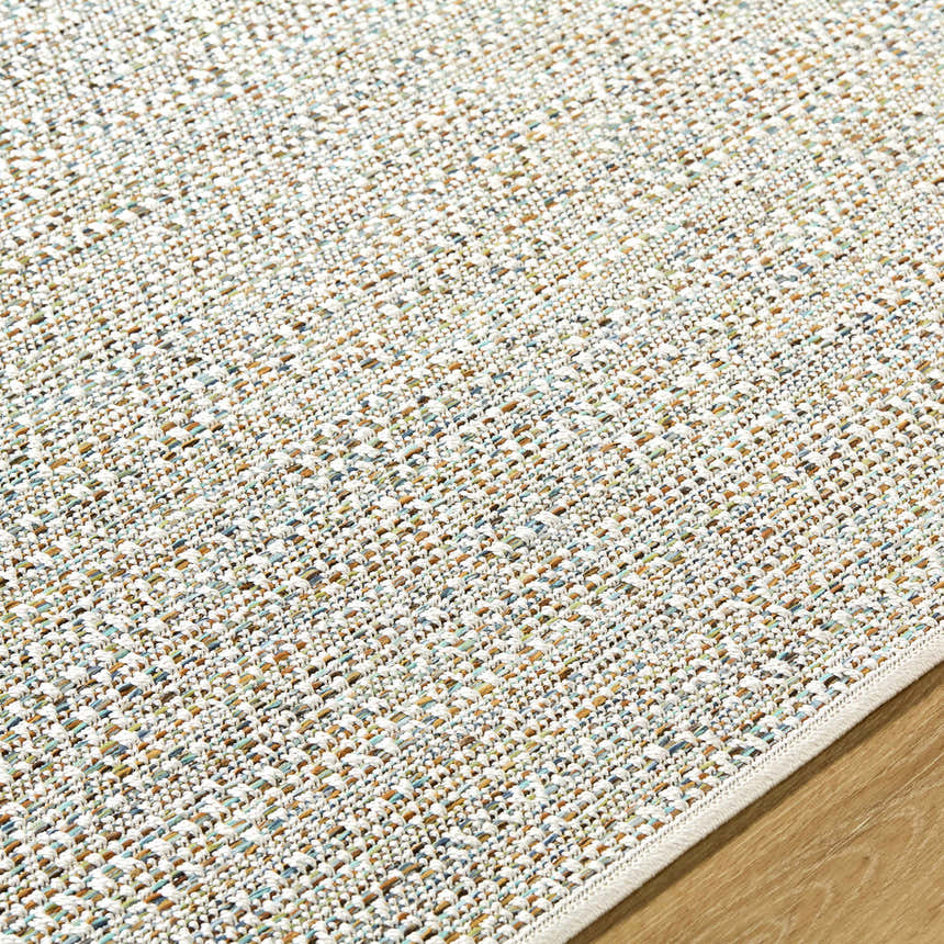 Close-up of the Thanh Ivory Area Rug showing its woven texture and colors: ivory, sandstone, and dove gray. Texture