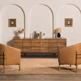 Living room scene with burnt orange Teresita Area Rug, wood cabinet, and two leather chairs. Roomscene-Rectangle
