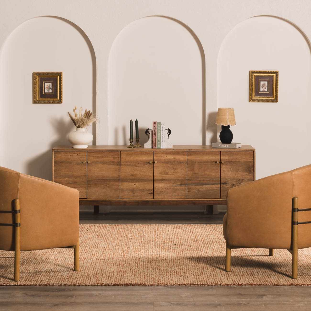 Living room scene with burnt orange Teresita Area Rug, wood cabinet, and two leather chairs. Roomscene-Rectangle