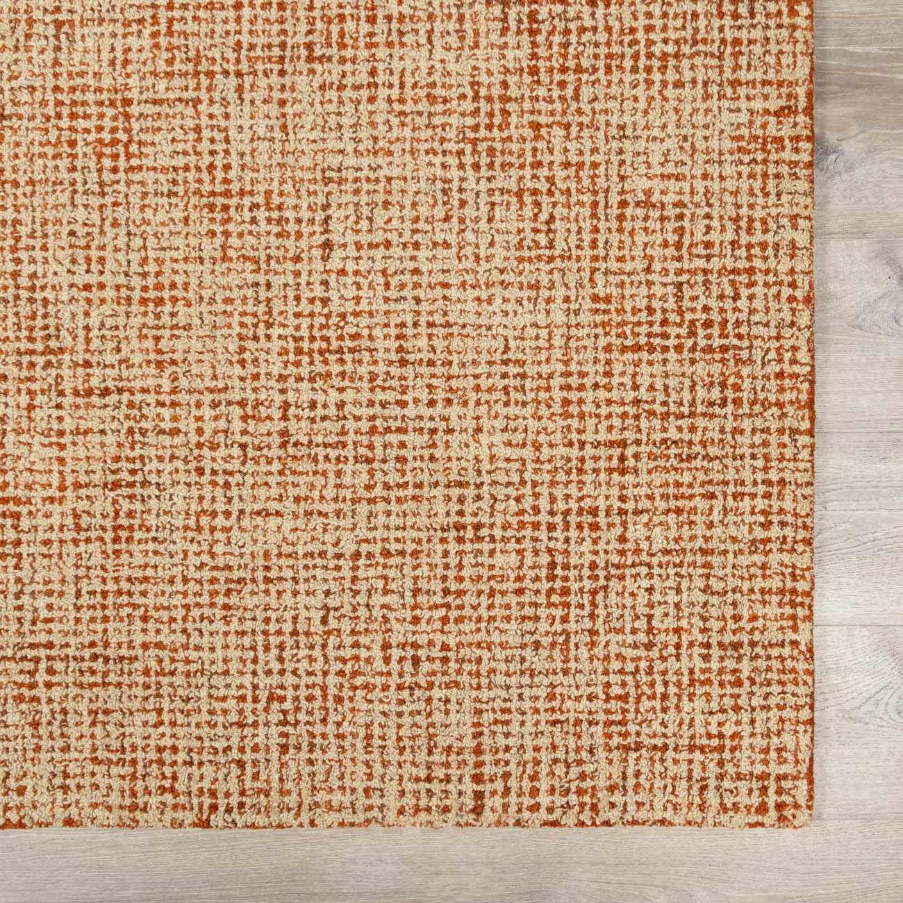 Close-up of the Teresita Area Rug. Burnt orange and ivory wool rug with a textured, grid-like pattern. Swatch