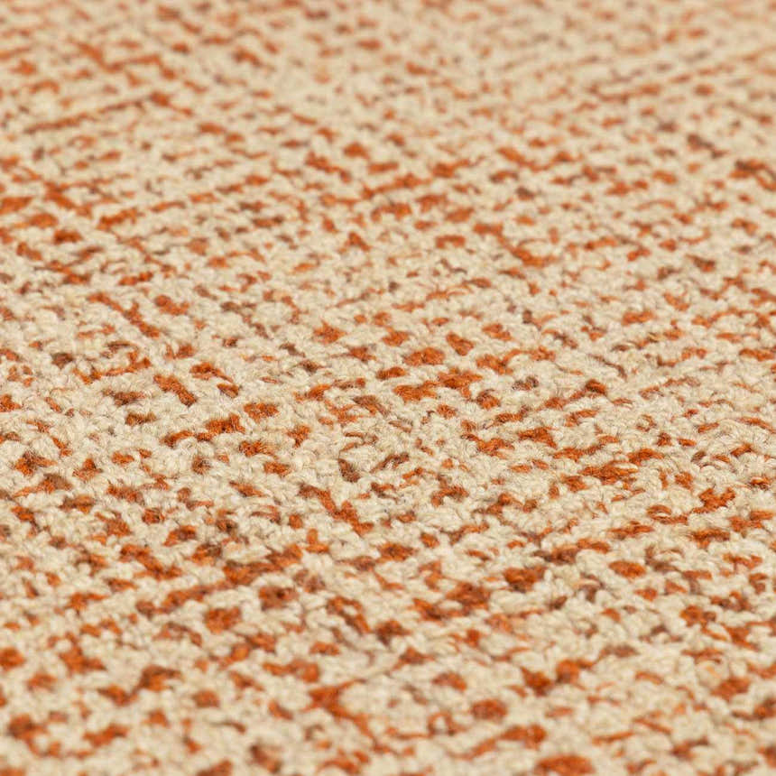 Close-up of the Teresita Area Rug showing the burnt orange and ivory wool texture and hand-tufted construction. Texture