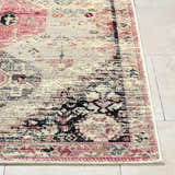 Close up of Trudy Area Rug showing a farmhouse style pattern in cream, pink, and black on tile flooring. Front