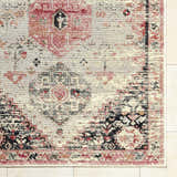Close up of the Trudy Area Rug featuring a traditional, distressed pattern in cream, red, and black. Corner