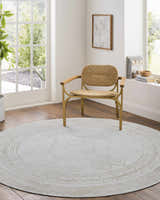 Light-filled room with a round Taban Luxe Rug in ash and silver gray under a modern chair. Farmhouse style. Roomscene-Round