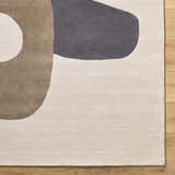 Close-up of the Terah Ivory Area Rug. Features a contemporary design with charcoal, taupe, and ivory colors. Hand-tufted wool texture. Swatch
