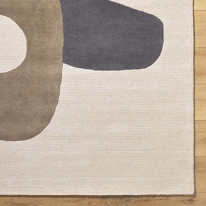Close-up of the Terah Ivory Area Rug. Features a contemporary design with charcoal, taupe, and ivory colors. Hand-tufted wool texture. Swatch