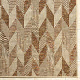 Close-up of the Andrea Burnt Sienna Area Rug. Geometric pattern in beige, rust, sandstone, and terracotta tones. Machine woven texture. Corner