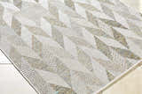 Close-up of the Andrea Ivory Area Rug featuring a geometric pattern in ivory, sage, sandstone, and sky blue hues. Corner