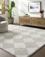Living room scene with a beige swivel chair and Achaia Beige Area Rug featuring a checkerboard pattern. Roomscene-Rectangle
