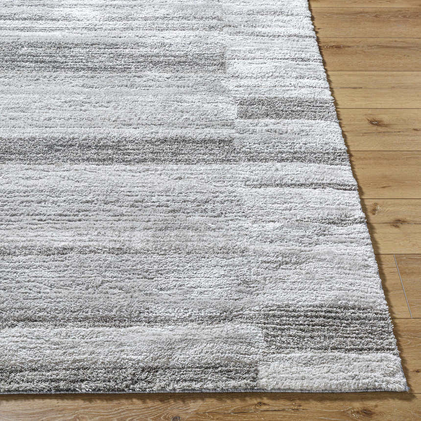 Close-up of the Tayla Shag Area Rug showing its light silver, sage, and silver gray horizontal stripe design and shag texture. Front