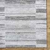 Close-up of the Tayla Shag Area Rug. Light silver, sage, and silver gray shag rug with a horizontal striped pattern. Corner