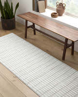 Entryway scene with a Cascade White Area Rug, wood bench, snake plant, and natural light. Roomscene-Runner
