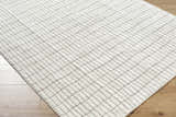 Close-up of the Cascade White Area Rug showing its ivory and taupe geometric pattern and soft, textured polyester pile. Corner