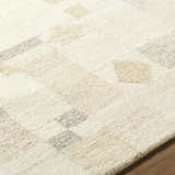 Close-up of the hand-tufted Tovah Area Rug. Ash and light silver wool rug with a contemporary geometric pattern. Texture