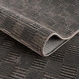 Close-up of the black Truls 3D Checkered Washable Rug showing its textured, geometric pattern and soft, plush pile. Fold