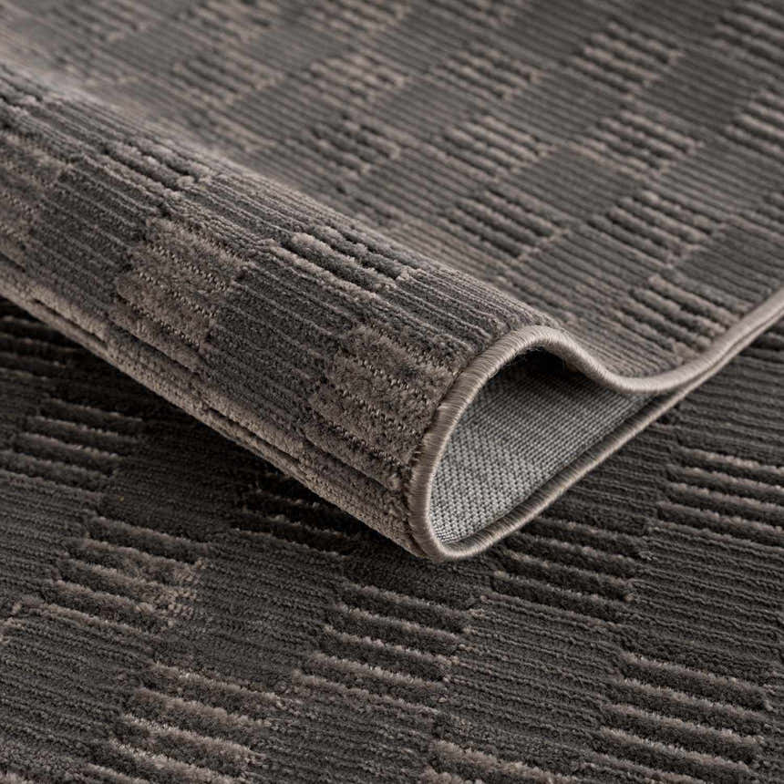 Close-up of the black Truls 3D Checkered Washable Rug showing its textured, geometric pattern and soft, plush pile. Fold