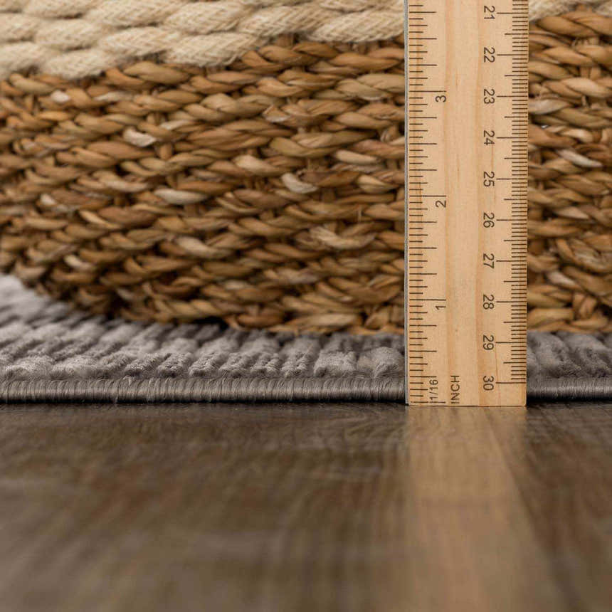 Close-up of the Truls 3D Checkered Washable Rug in black and gray, showing the texture and pile height. Ruler included. Pile
