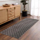 Entryway with wood floors and Truls 3D Checkered Washable Rug in Black, styled with a console table and olive tree. Roomscene-Runner
