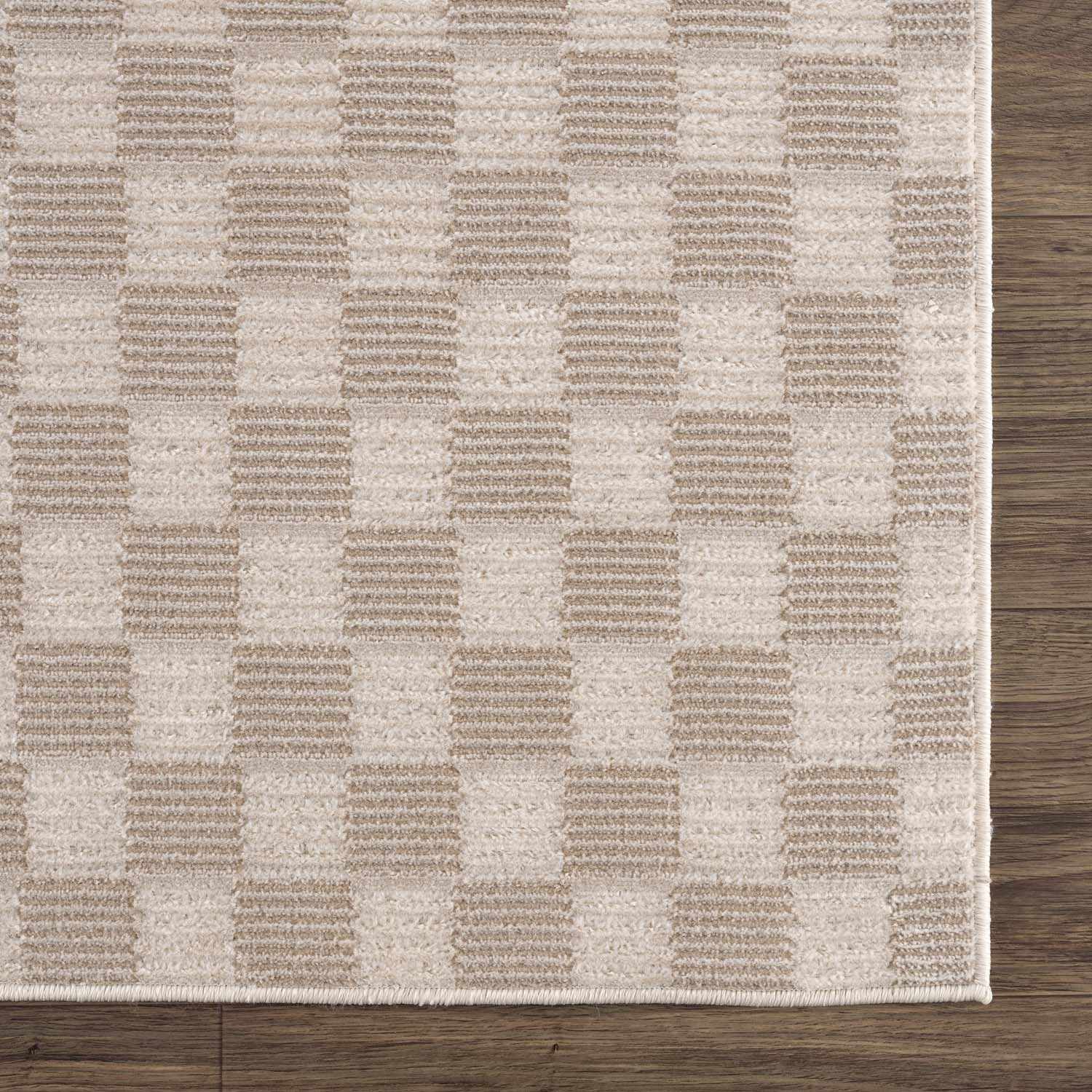 Close-up of the Truls 3D Checkered Washable Rug in Biscotti. Beige and cream checkered pattern. Machine woven polyester rug. Swatch