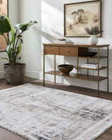 Living room scene with a tan console table and the Taszi Luxe Thick Area Rug in black, ivory, peach, and tan. Roomscene-Rectangle