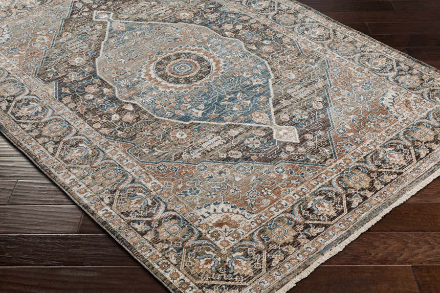 Close-up of the traditional Baychester Brown Area Rug, featuring dark brown, denim, and sage tones. Corner