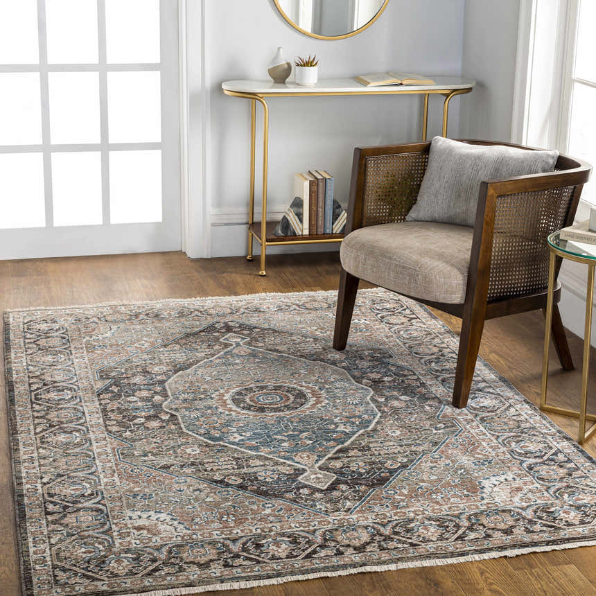 Living room scene with a brown cane chair on a Baychester Brown Area Rug. Traditional style with blue, pink and sage accents. Roomscene-Rectangle