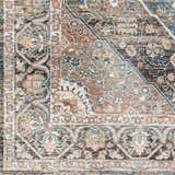 Close-up of the Baychester Brown Area Rug, showcasing its traditional floral pattern and dark brown, denim, and dusty pink colors. Swatch