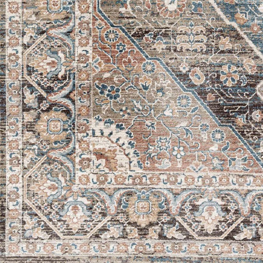 Close-up of the Baychester Brown Area Rug, showcasing its traditional floral pattern and dark brown, denim, and dusty pink colors. Swatch