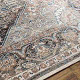Close up of the Baychester Brown Area Rug, showcasing its traditional oriental pattern and brown, denim, and sage colors. Texture