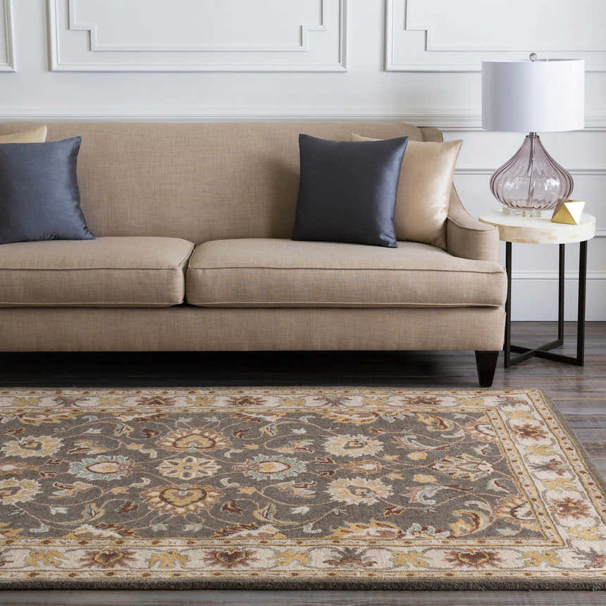 Living room scene with a Cherryfield Hand Tufted Taupe Wool Rug, beige sofa, blue pillows, and marble side table. Roomscene-Rectangle
