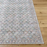 Close-up of the Telma Medium Green Washable Area Rug, showcasing its traditional pattern and colors of green, blue, and cream. Front