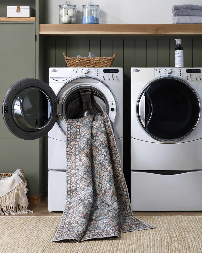 Telma Medium Green Washable Area Rug in a laundry room with a washing machine and dryer. Easy to clean rug. Washing-Machine