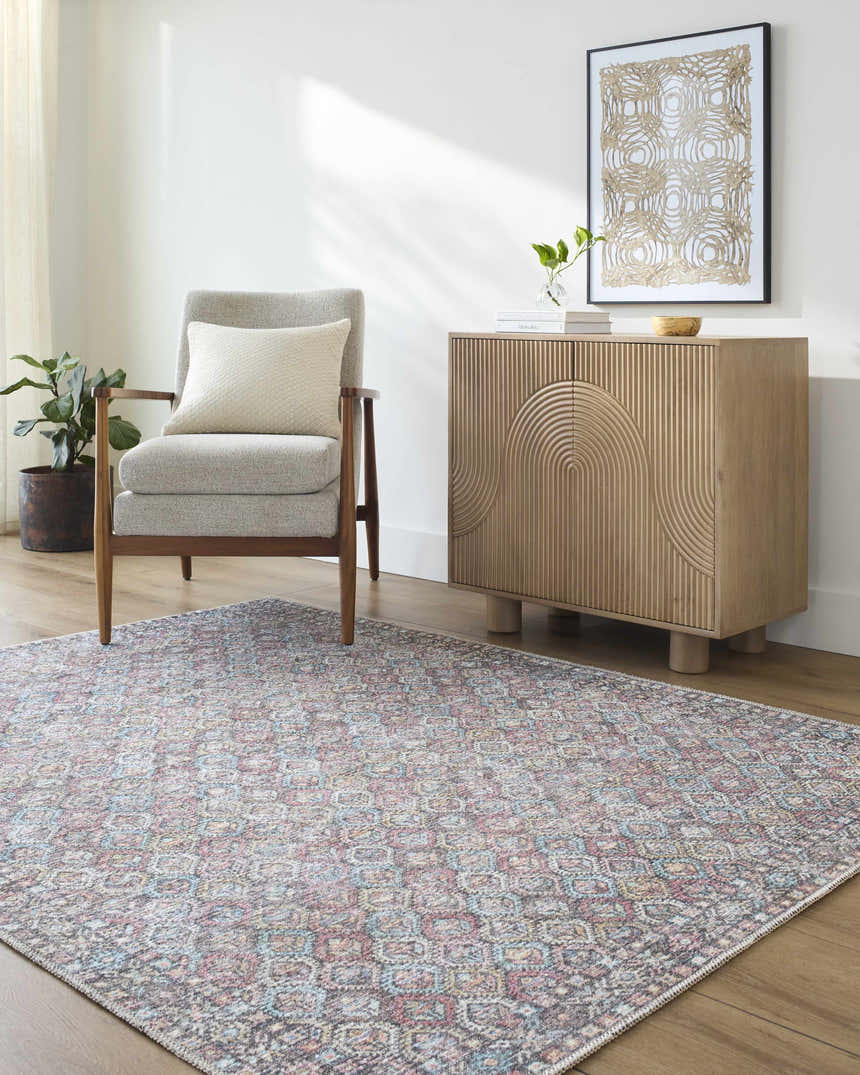 Living room scene with gray chair, wood cabinet, and Telma Red Washable Area Rug with red, aqua, and cream geometric pattern. Roomscene-Rectangle