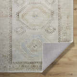 Close up of the hand tufted Tarun Area Rug, featuring a traditional beige, ivory, and sky blue pattern. Fold