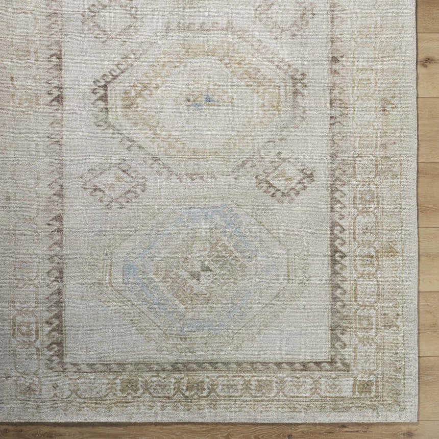 Close up of the hand-tufted Tarun Area Rug. Beige, ivory, and sandstone colors with traditional, geometric patterns. Swatch