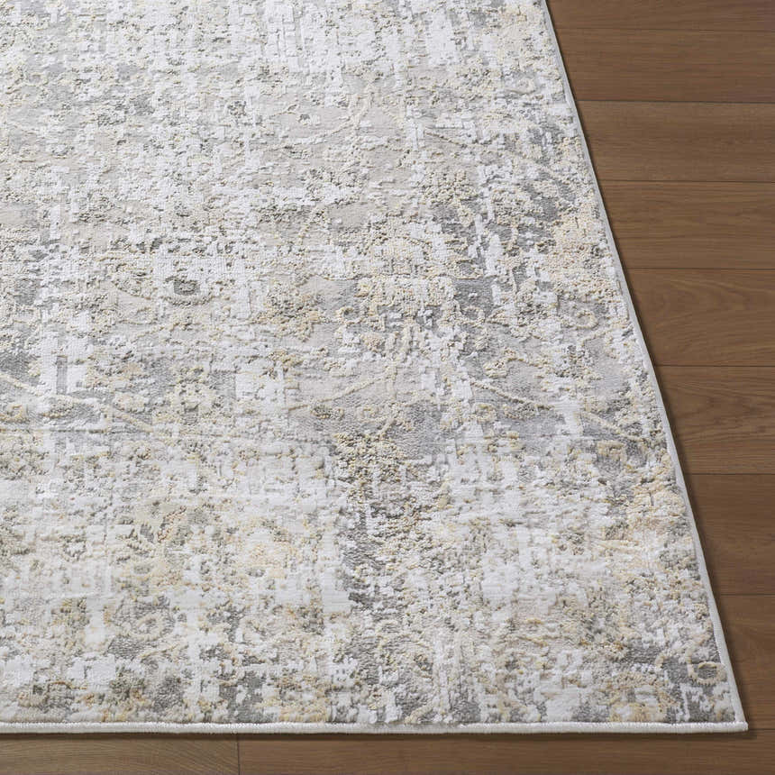 Close-up of the Tiago Area Rug showing its beige, charcoal, and cream contemporary design and soft texture on wood floors. Front