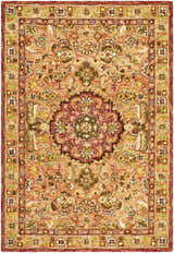 Detailed texture of the hand-tufted wool Annick Area Rug with a traditional floral pattern in orange, red, and green. Design-Rectangle-576