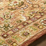 Close-up of the hand-tufted Annick Area Rug, a farmhouse style rug in wool with a traditional floral pattern. Texture