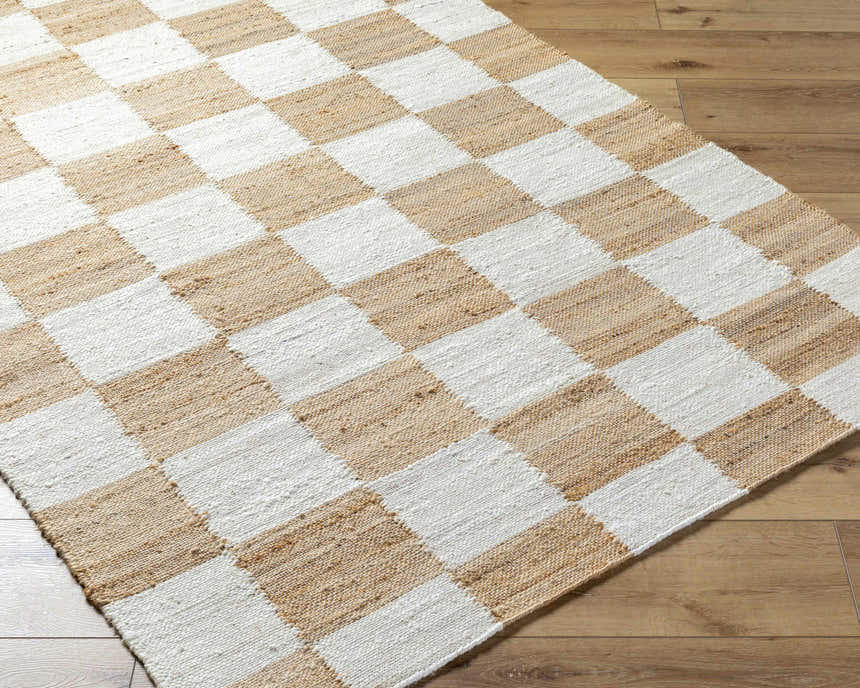Close-up of a hand-woven Tyhir Checkered Jute Rug with a light brown and white checkerboard pattern. Corner