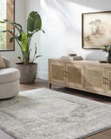 Living room scene with a beige chair, light wood cabinet, and the Vaeda Blue Thick Luxe Rug. Roomscene-Rectangle