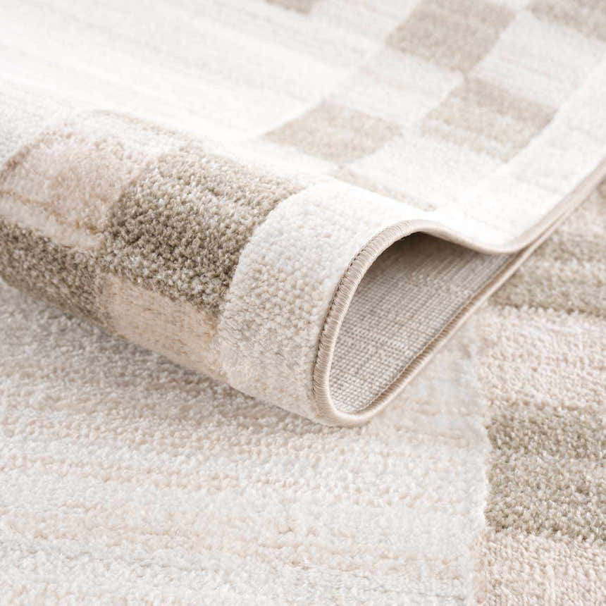 Close-up of the Azrika Beige Checkered Washable Rug, showing its soft texture and geometric pattern in beige and brown tones. Fold