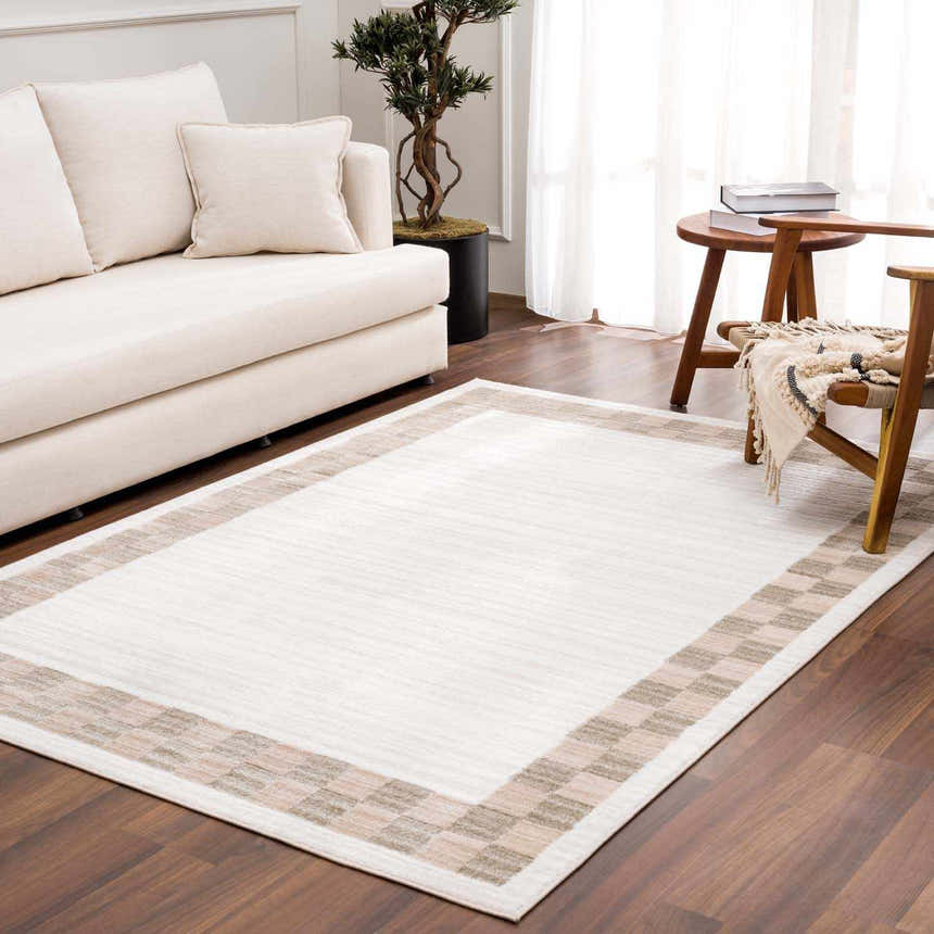 Living room scene with Azrika Beige Checkered Washable Rug, cream sofa, wood chair, and dark wood floors. Roomscene-Rectangle