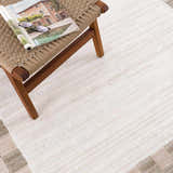 Close-up of Azrika Beige Checkered Washable Rug texture and pattern. Beige and brown checkered design. Modern style. Styleshot