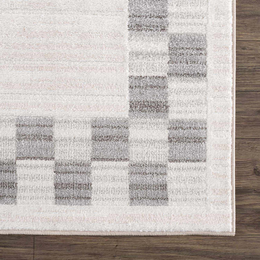 Close-up of the Azrika Gray Checkered Washable Rug. Beige, gray, and light gray checkered pattern. Machine woven texture. Swatch