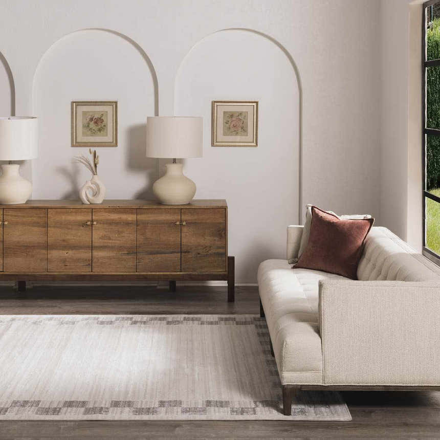 Living room scene with beige sofa and wood cabinet featuring the Azrika Gray Checkered Washable Rug. Roomscene-Rectangle