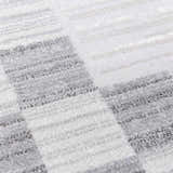 Close-up of the Azrika Gray Checkered Washable Rug, featuring a geometric beige and gray pattern. Texture