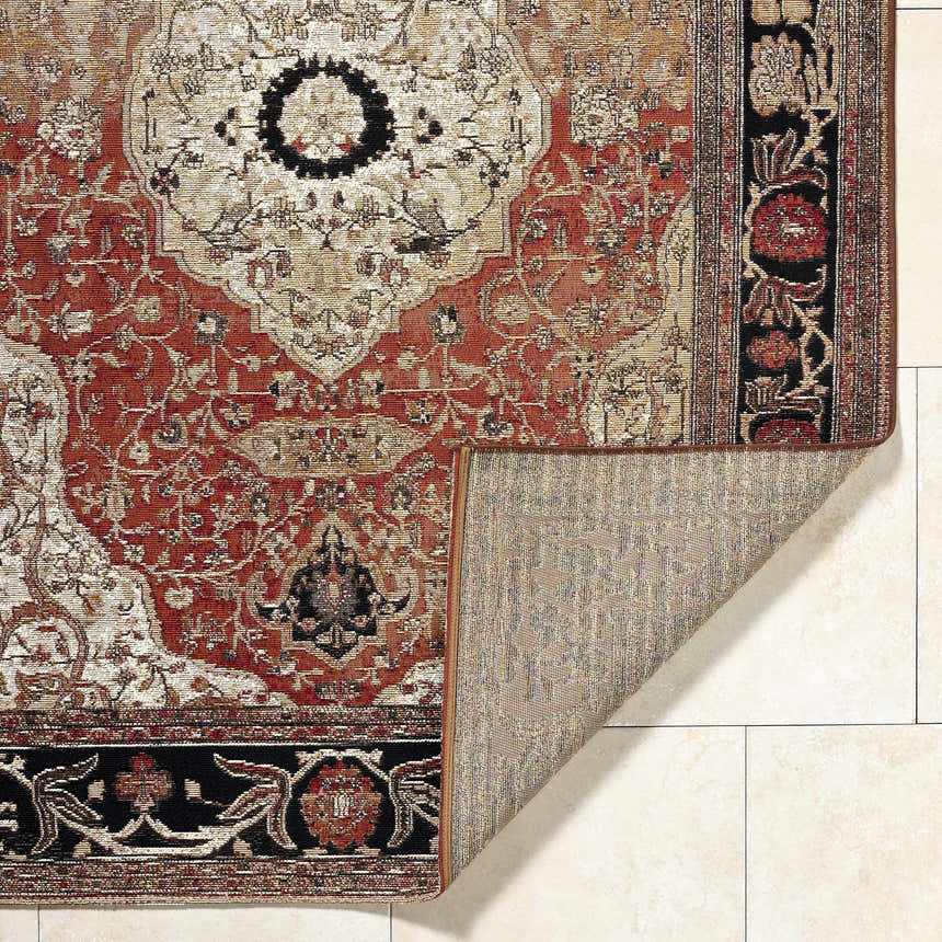Close-up of the Vonda Area Rug showing its traditional crimson, ivory, and charcoal floral pattern and machine-woven texture. Fold
